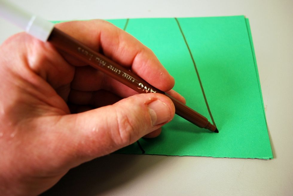 You can cut freehand or draw a wing and a tail shape on the folded paper.