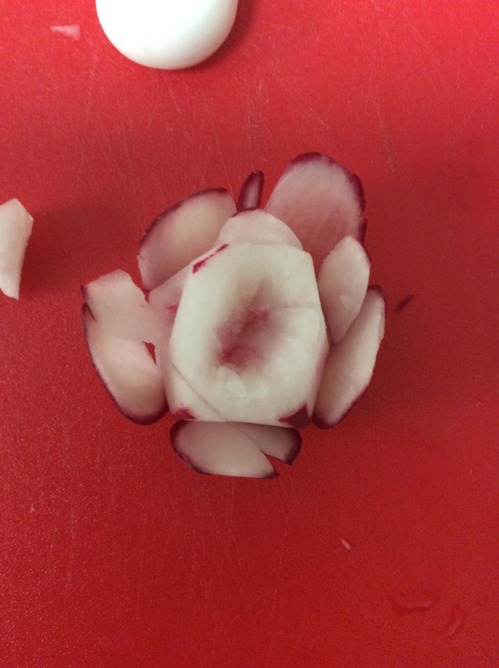You can cut out the center of the radish to add to the flower look.