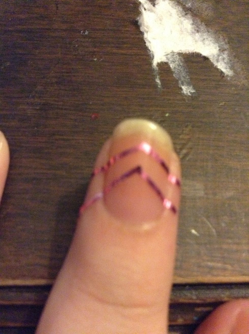 You can cut regular tape into a little chevron stripe shape. Put it on the middle of your nail.