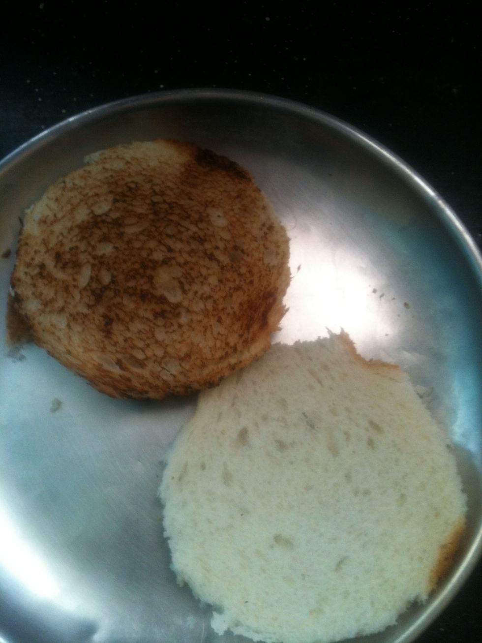 You can cut up the bread however you want to. I like a circular Burger-shaped bread. And then you need to toast it.
