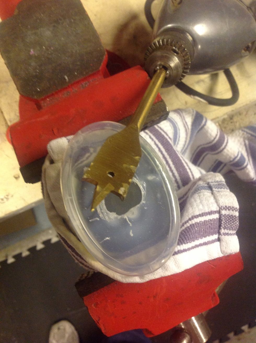 You can do this next step by free handing it. I chose to wrap a towel around the soap bottle, insert in a vise and tighten up. Now the vise is holding the bottle.