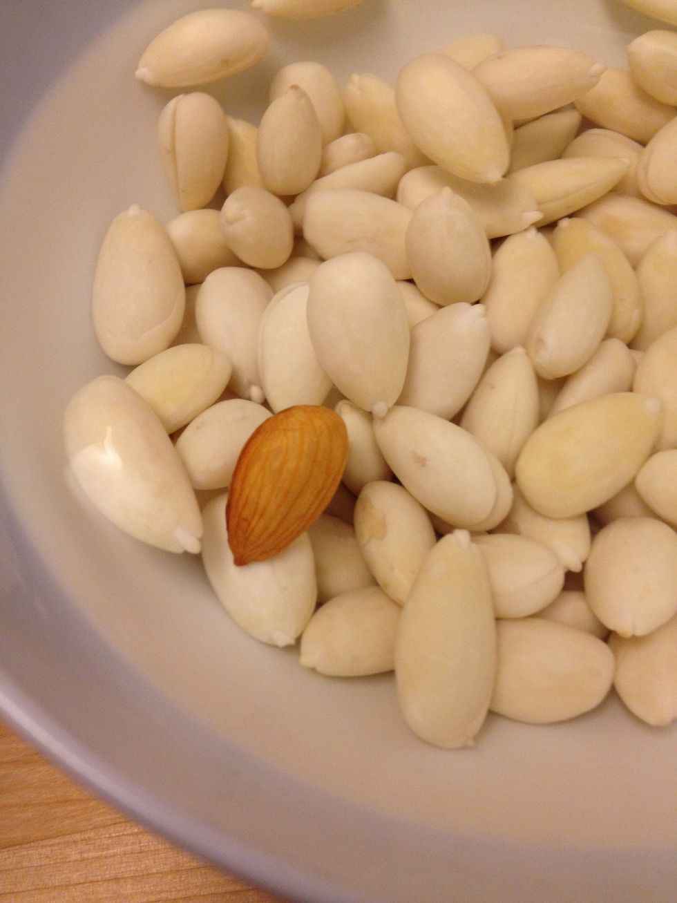 You can either keep the skin (to save time) or manually remove the skin to maximize the taste. Otherwise, you can buy almond that already has the skin off but you'll still need to soak overnight.