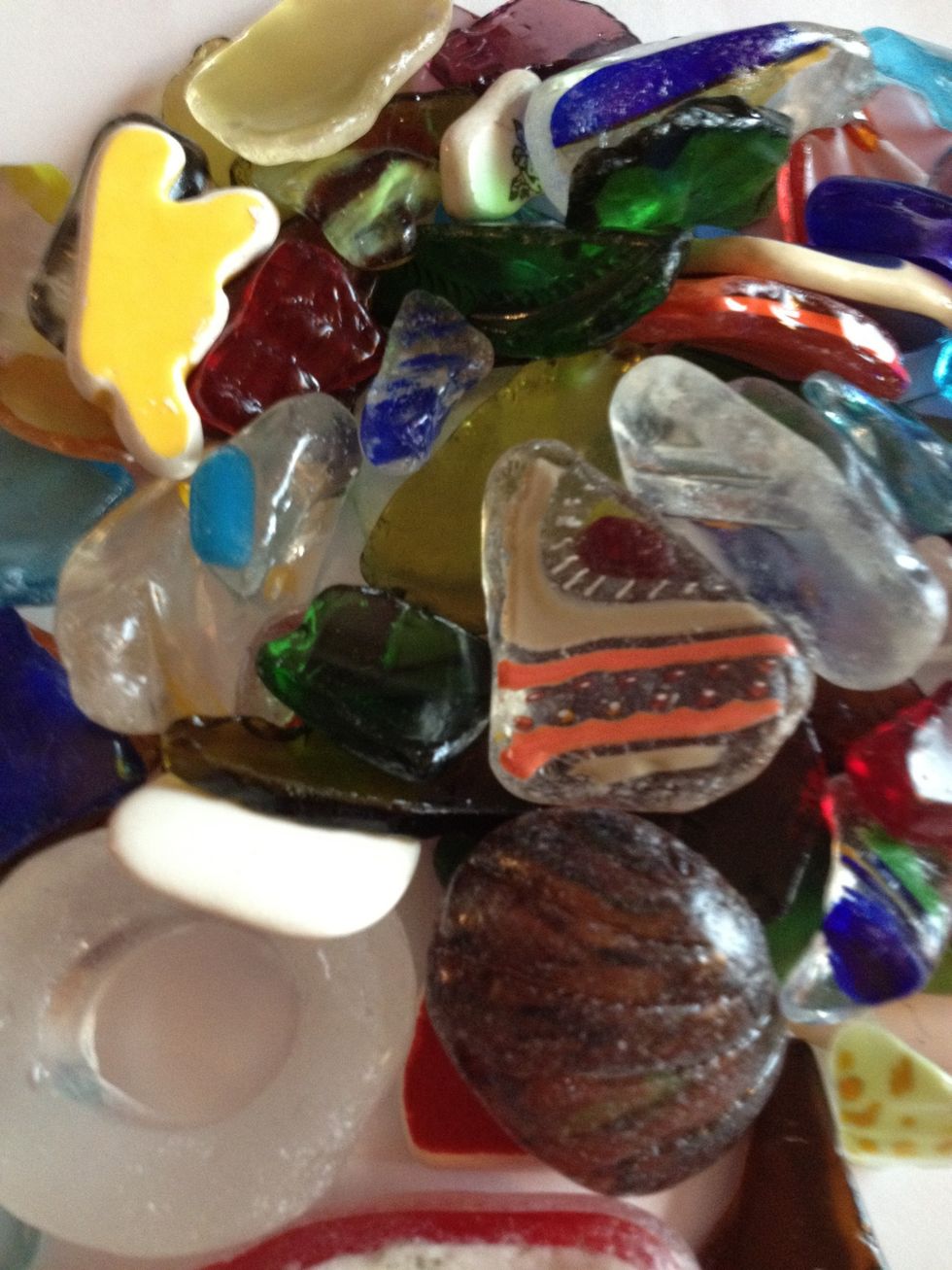 You can get the same effect by putting pieces of glass in rock tumblers or even cement mixers. For $2, I got all these at a local recycling center that tumbles pieces of glass in cement mixers.