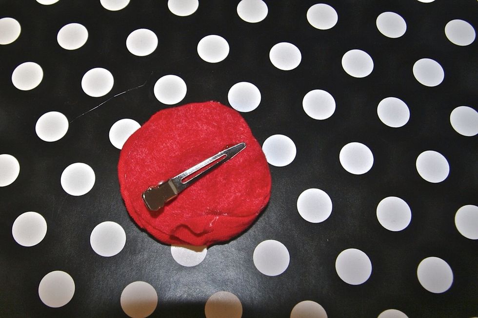 You can glue it on to an alligator hair clip or a headband or a shirt etc.