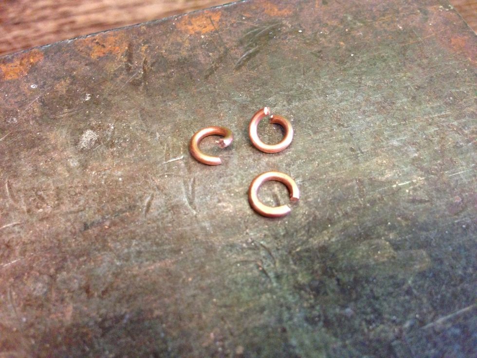 You can lightly hammer each jump ring to flatten it very efficiently, but don't go too far. You don't want to turn them into disks.