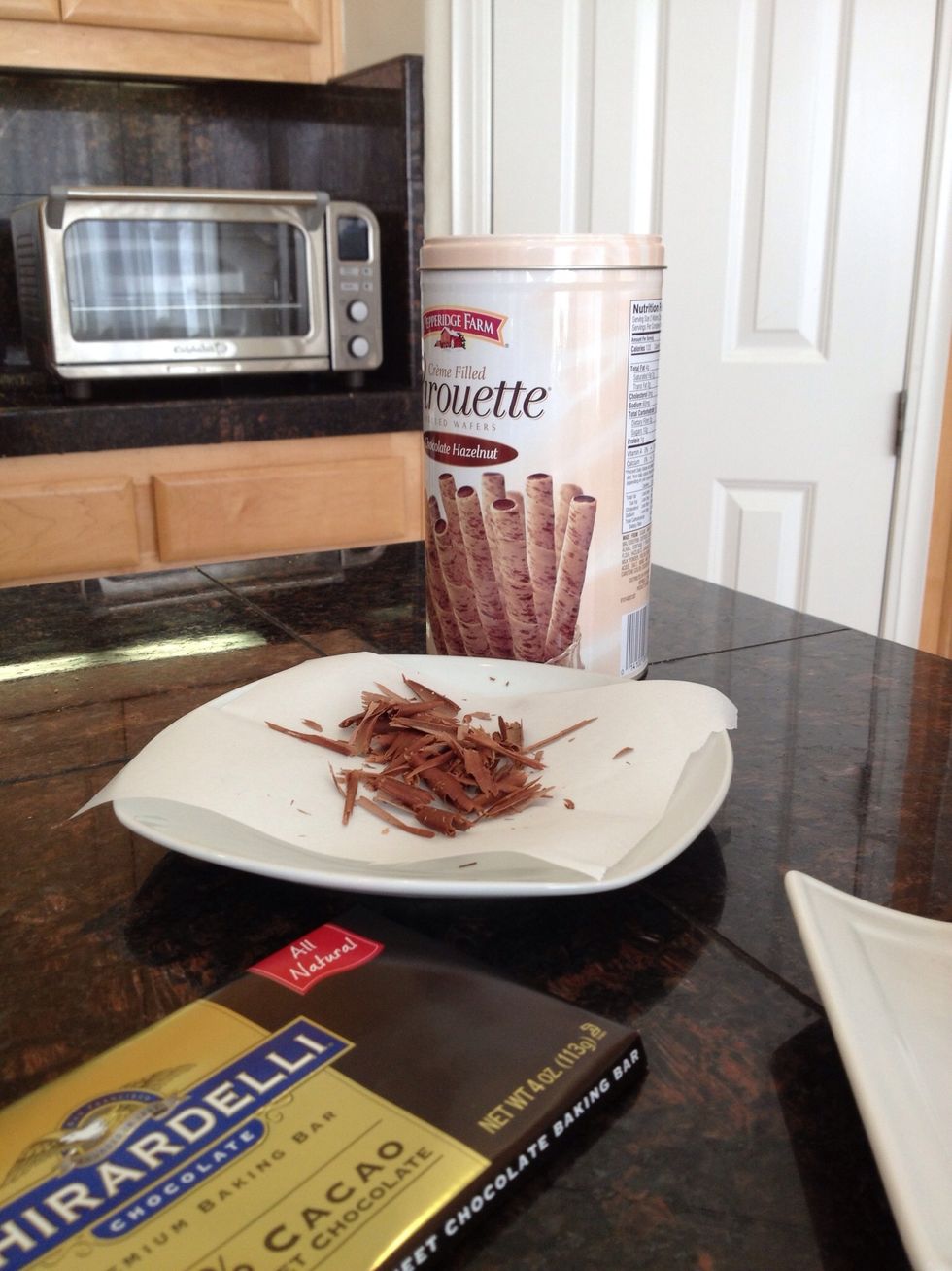 You can make chocolate shavings by running a sharp knife along the back of a bar of chocolate.
