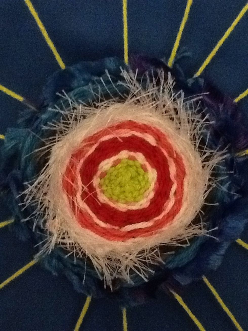 You can make your weaving small or large. When you have it like you want it, leave enough yarn at the end to tie onto a knot already on the back. Leave it on the hanger.