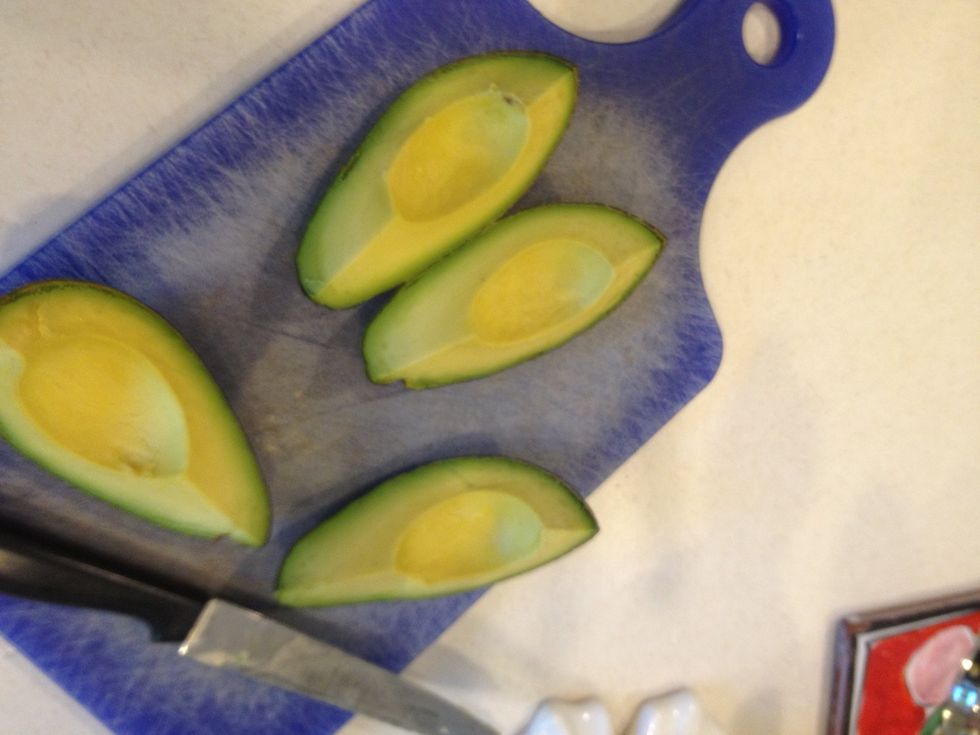 You can now easily pop out the pit. You now have an avocado cut in lengthwise quarters.