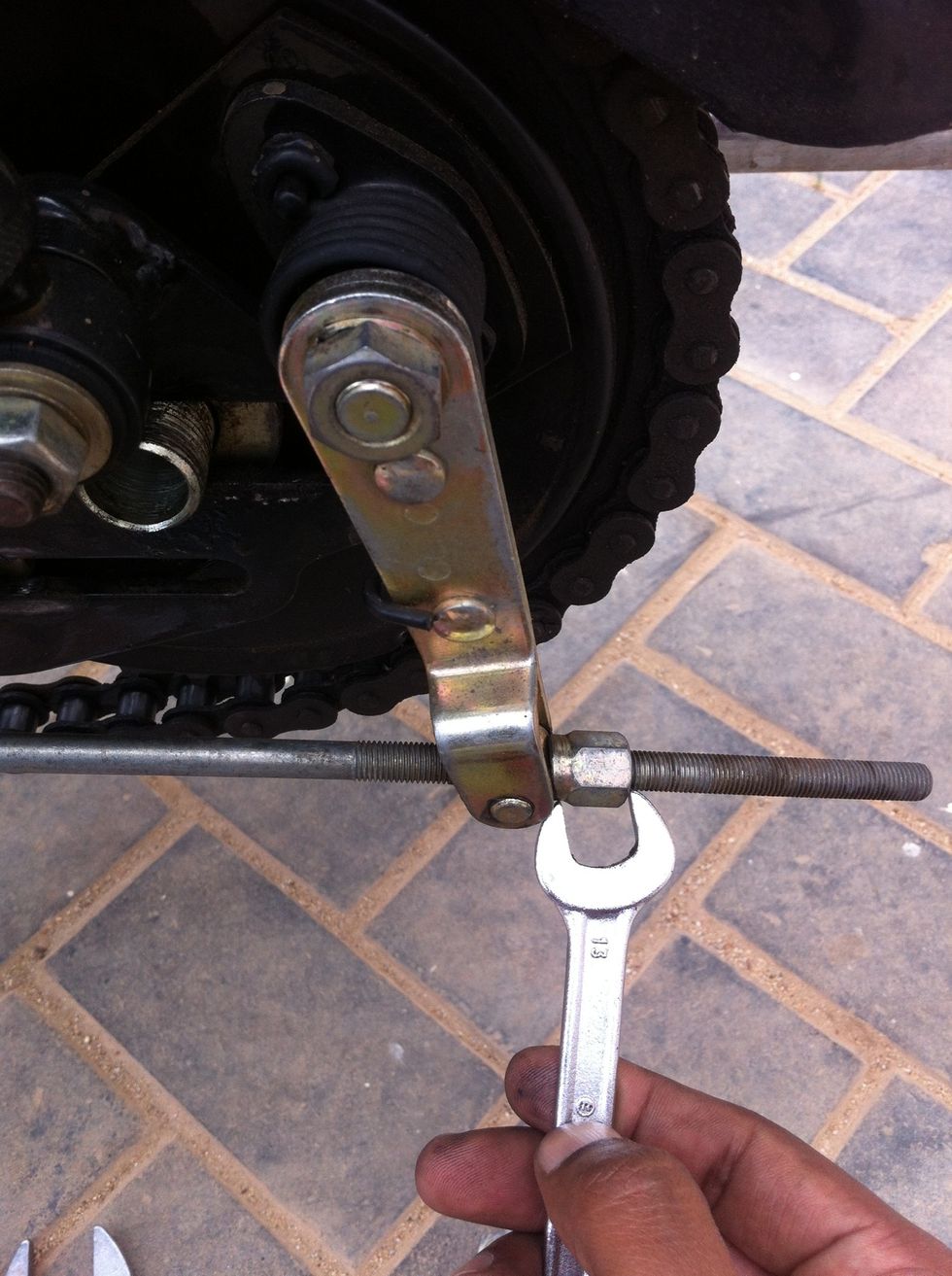 You can now remove the brake rod using a 13mm spanner