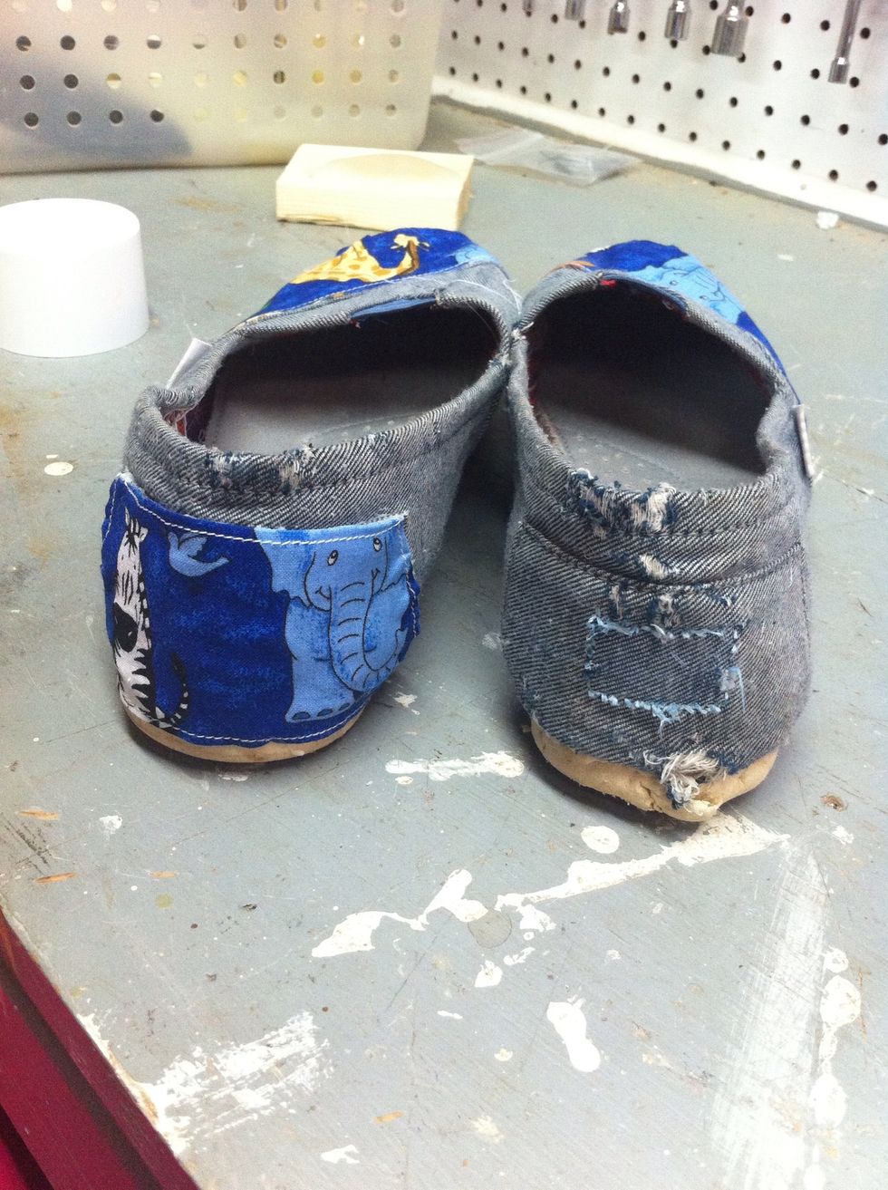 You can remove the TOMS logo or you can work around it. Spray the Spray Adhesive, add your fabric, and hot glue any fly aways.