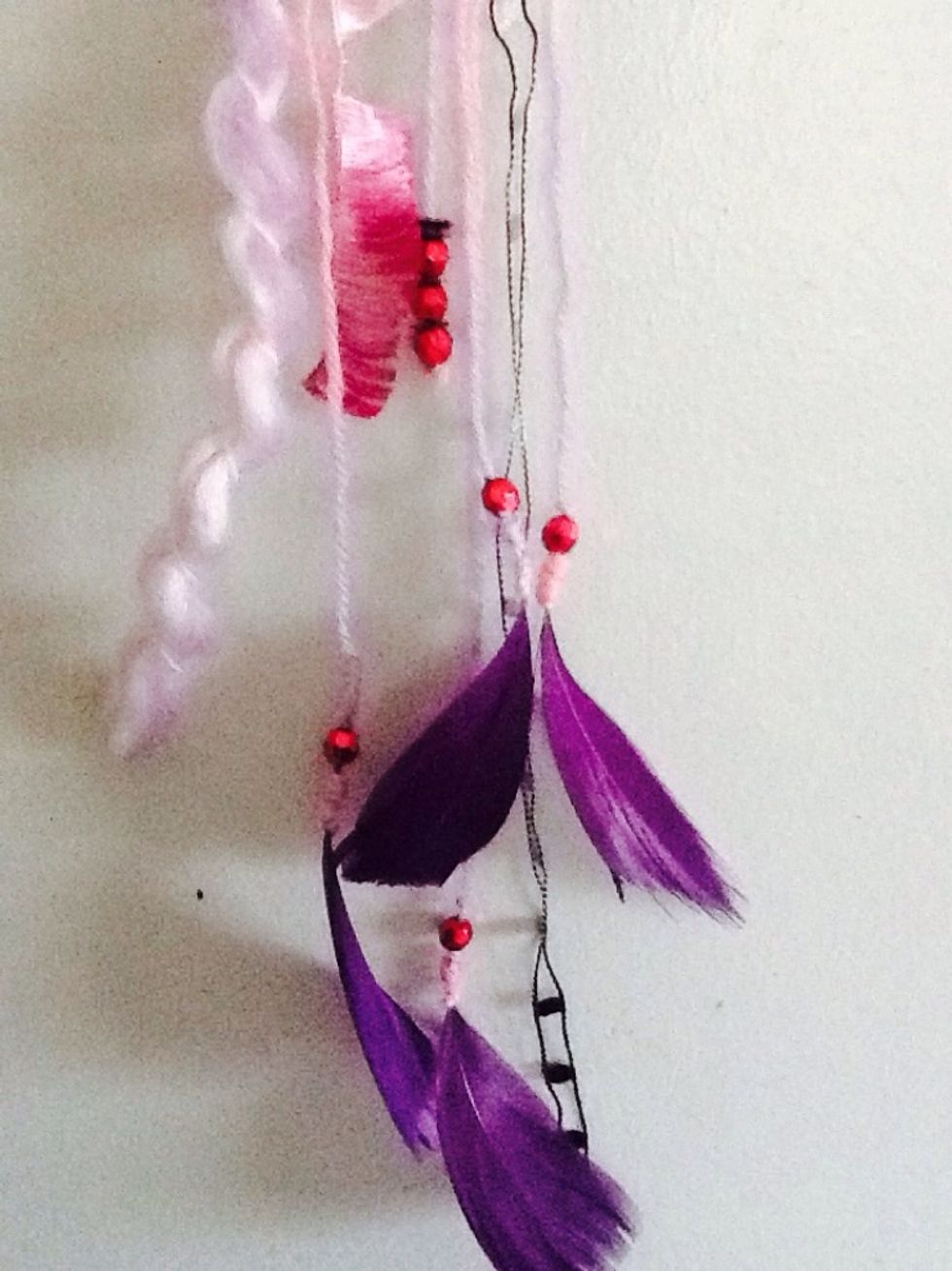 You can see here in the final product, that I hung feathers, beads, sequins, and different textured yarns.