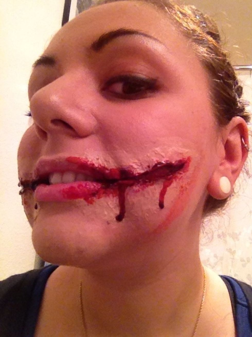 You can take some wet blood and smear it around the rest of your face if you like or uses it as accent around your neck... it's up to you get creative