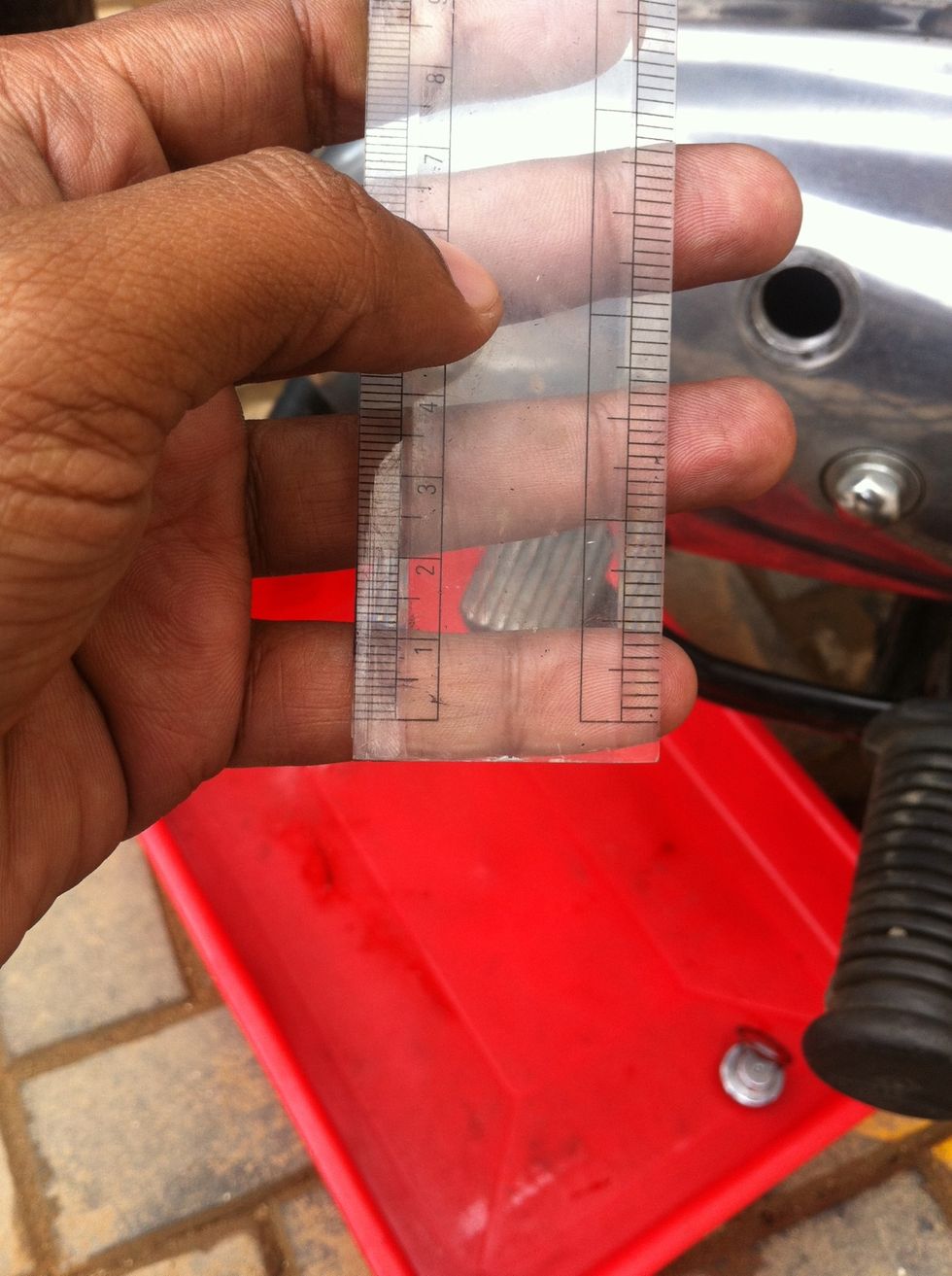 You can use a normal ruler which has both mm and inch measure ( Borrow the tool from your school goer ). 5 - 6mm or 1/4th of an inch is the slack recommended