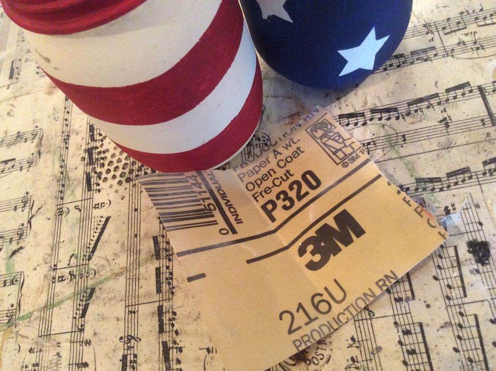 You can use a very light grit sandpaper to softly sand and distress your jars a bit.