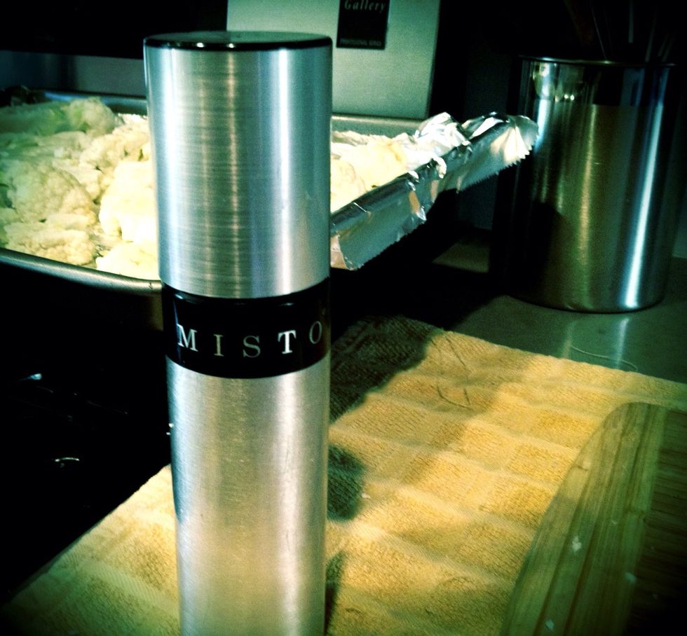 You can use any kind of spray bottle, or invest in this awesome gadget! No added chemicals, fill it w/ any kind of oil.  (Search "misto" on amazon.com)