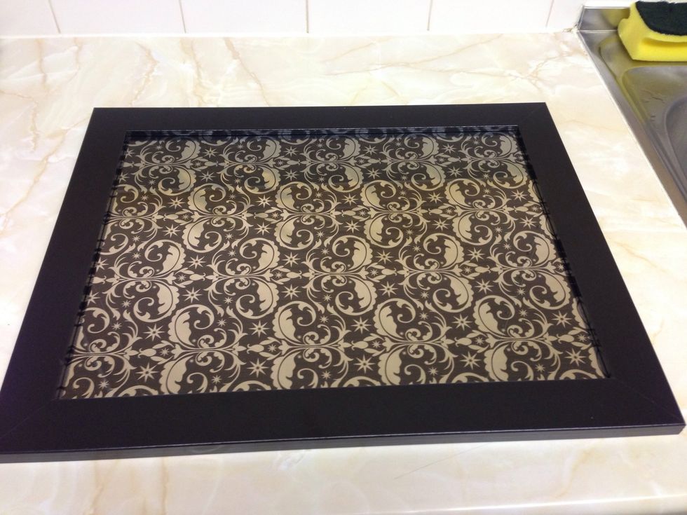 You can use any picture, poster or photo of your choice.. I used some wrapping paper and drew round the back frame for correct size. Place the glass back in frame and clip the back on...