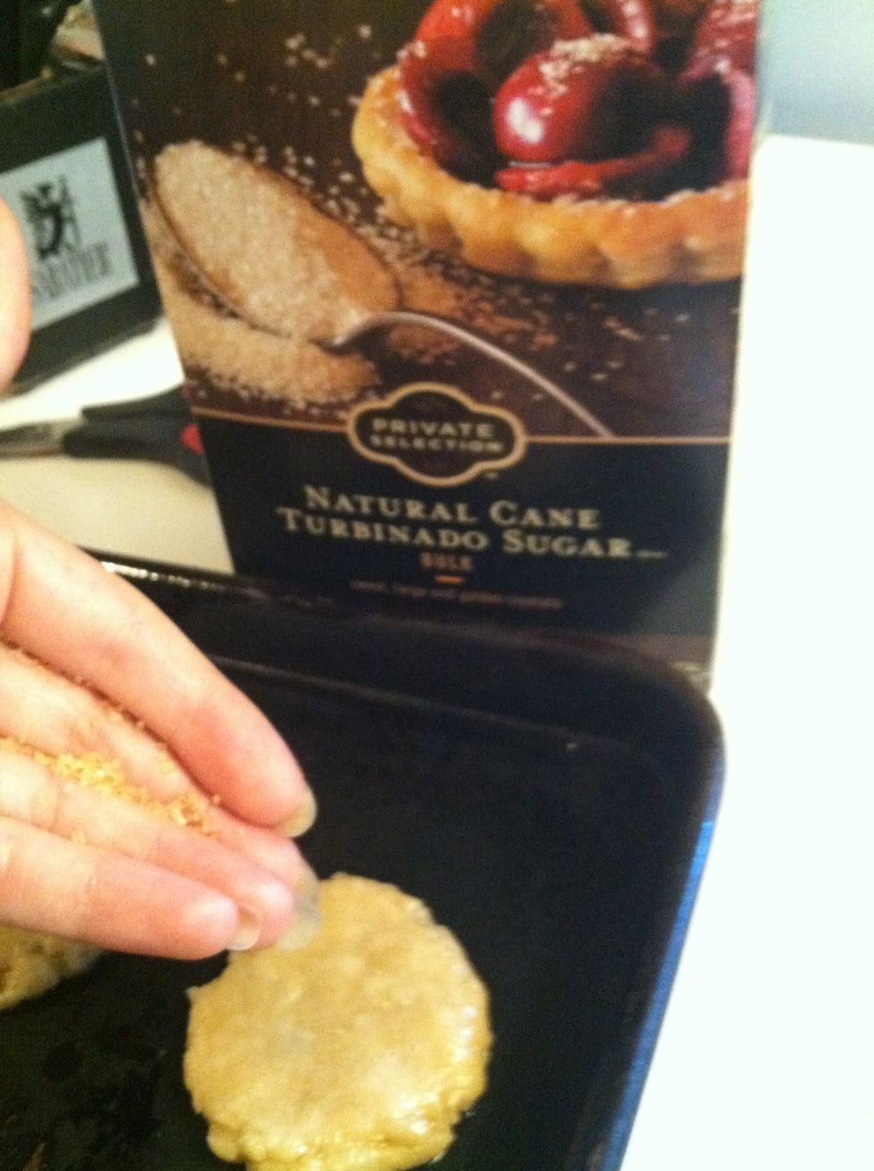 You can use any type of sugar or jimmies as a topping. As you can see, I just used cane sugar. (My hands look pretty greasy from forming the cookies!)