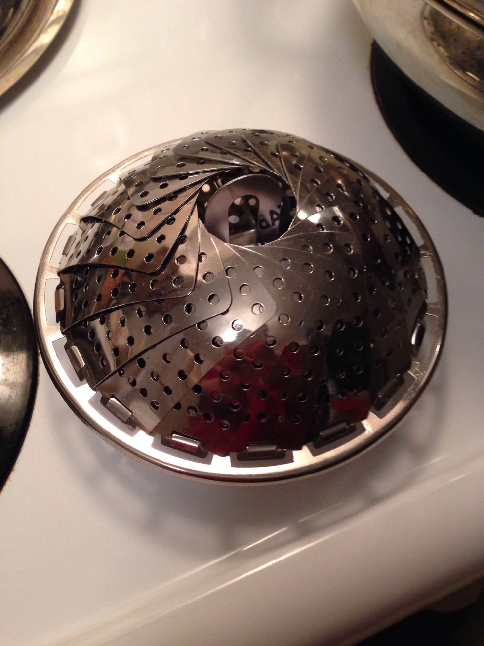 You can use this instead. Put it in a regular pot with some water (bellow the bottom of this thingy) and it will work the same way. Put a paper towel under your pot's lid to avoid dripping water.