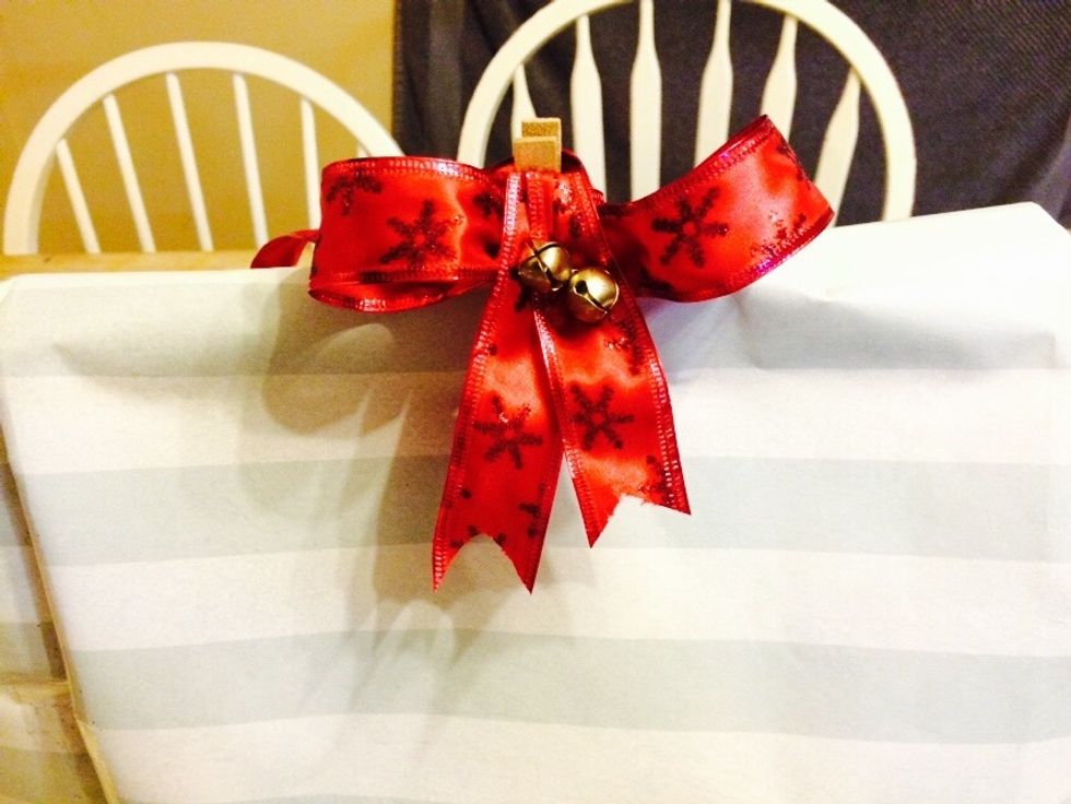 You could tape it down or use a clip. I've got a laundry clothespin with a bow. Enjoy!