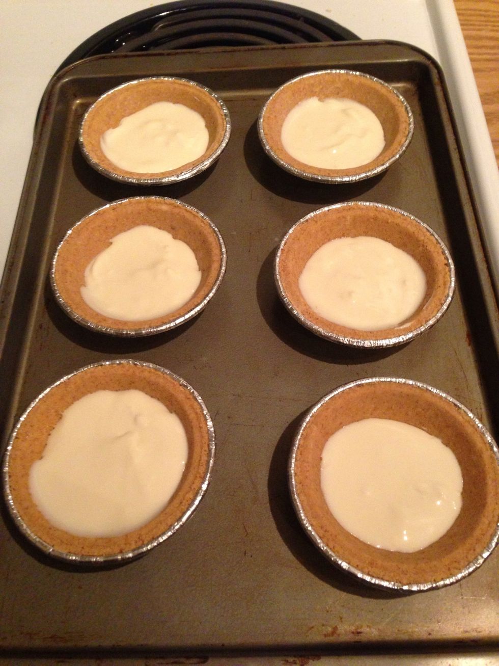You definitely can just scoop them right in, but I like separating my mixture in half right away so I know what amount I am working with. (Repeat this step for the other 6 pie crusts you have.)