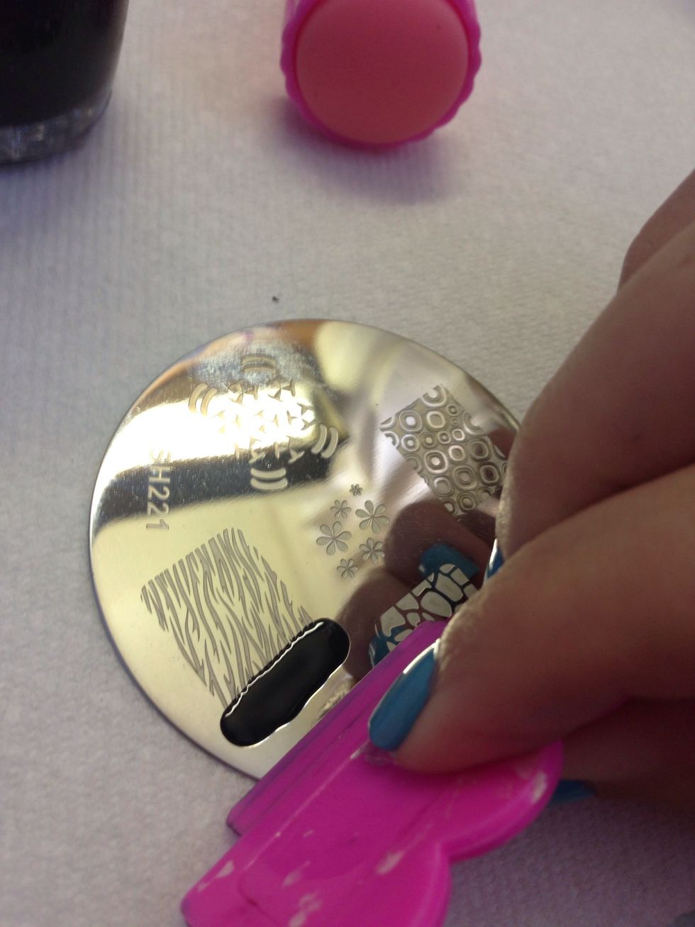 You don't really have to paint over the entire design. Just a spot with plenty of polish at one end will be enough.