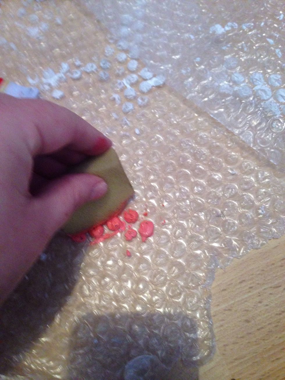 You don't want a lot of paint so dab the sponge on something scrap to remove any access paint