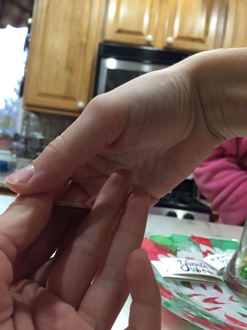 You drop the coin into the hand that it was in.
