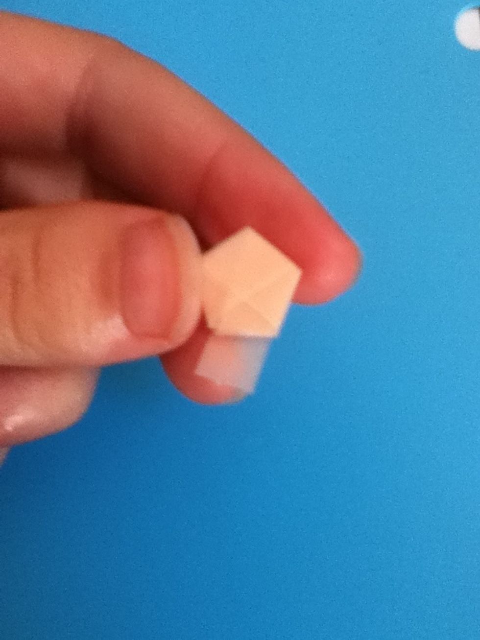 You have a short tail left. Flip your paper so that the tail is coming from the back, as though you were going to continue folding.