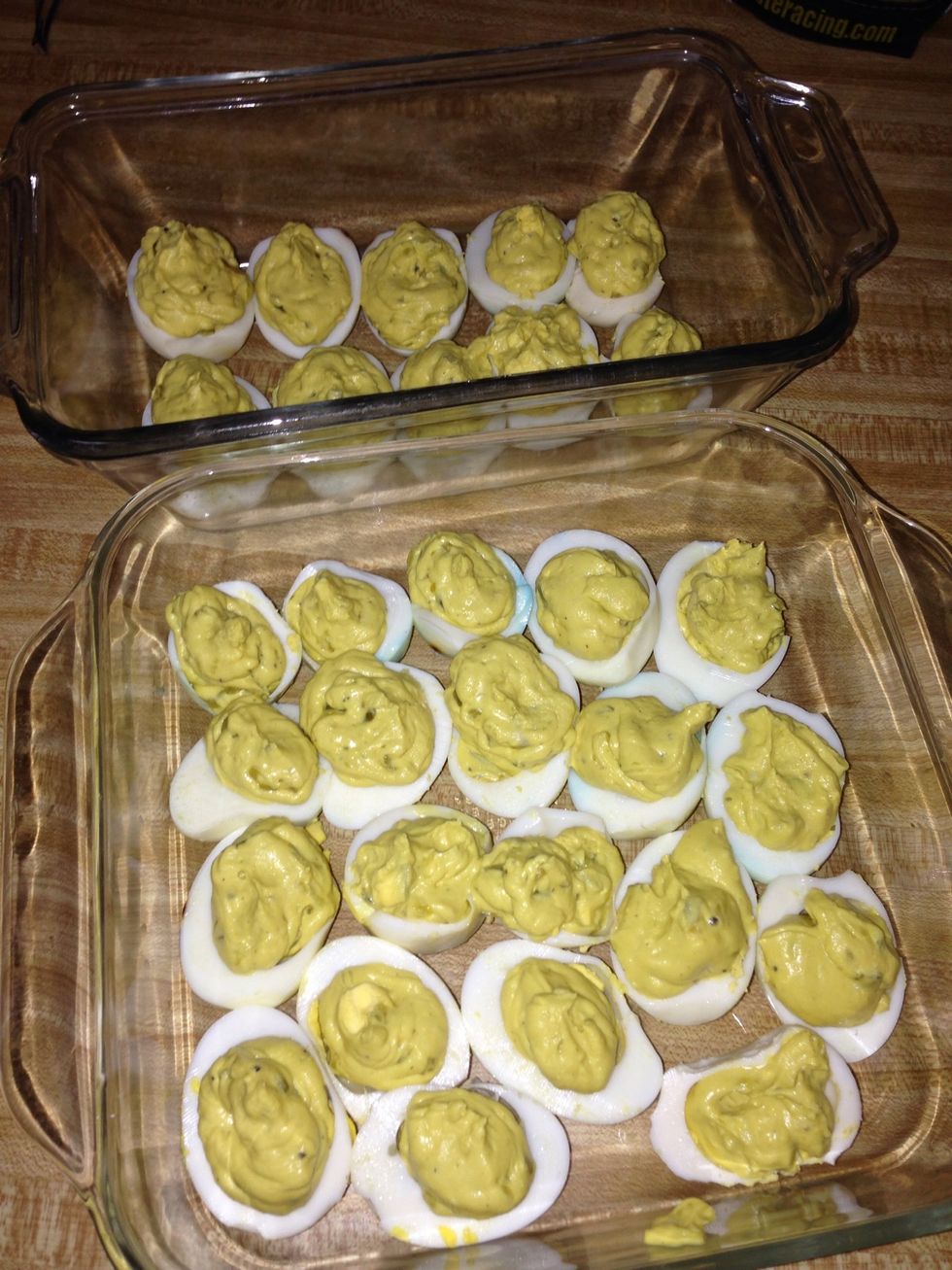 You have made a piping bag with the zipper bag. Fill all of the egg cups with the yolk mixture.