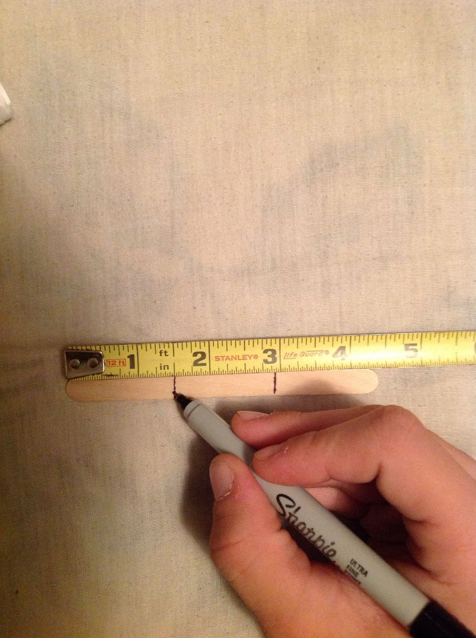 You have to measure one and a half inches on both sides of the popsicle stick and mark it.