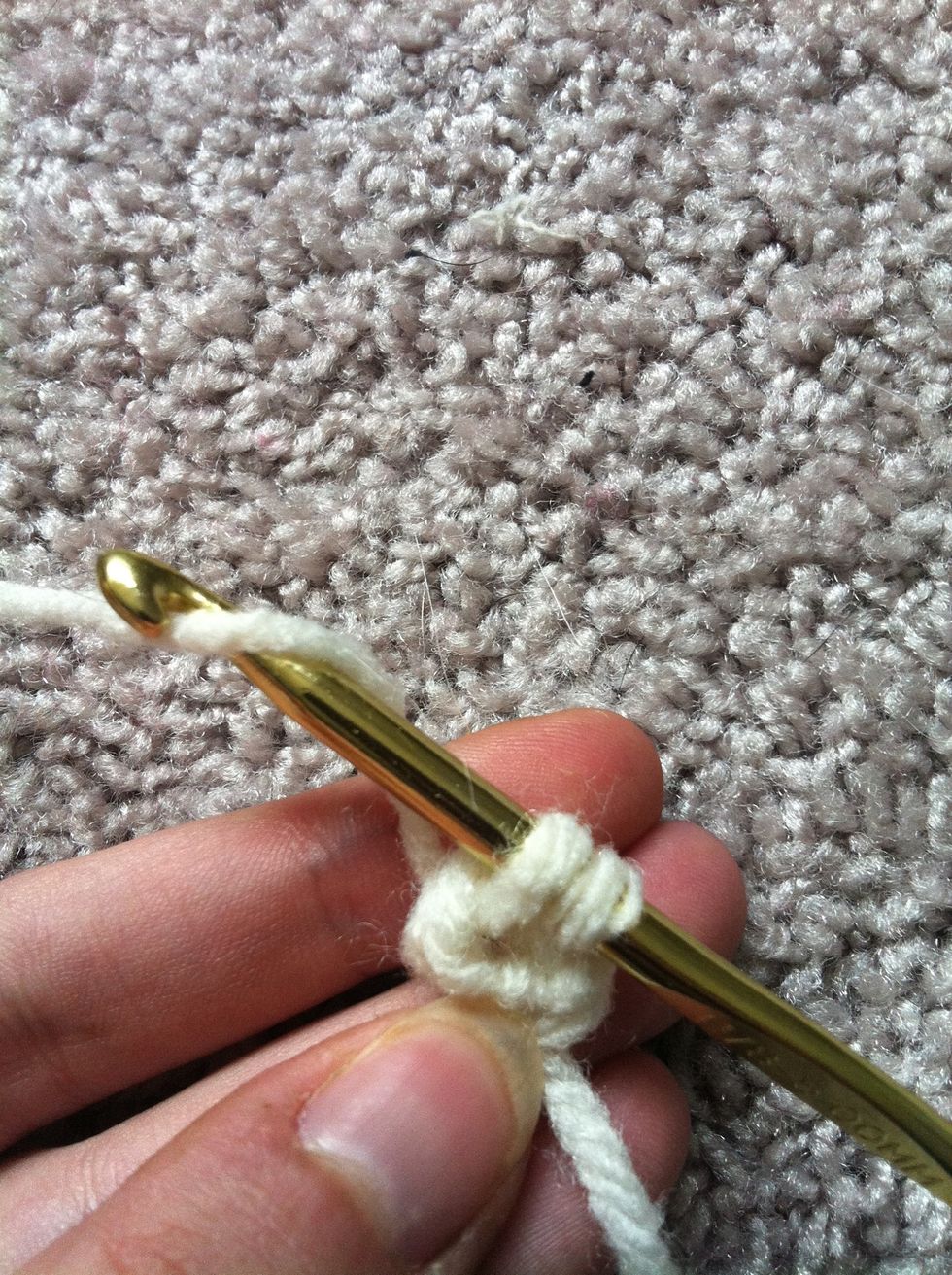 you have two loops on your hook. yarn around an pull through both loops on your hook to finish you first single crochet.
