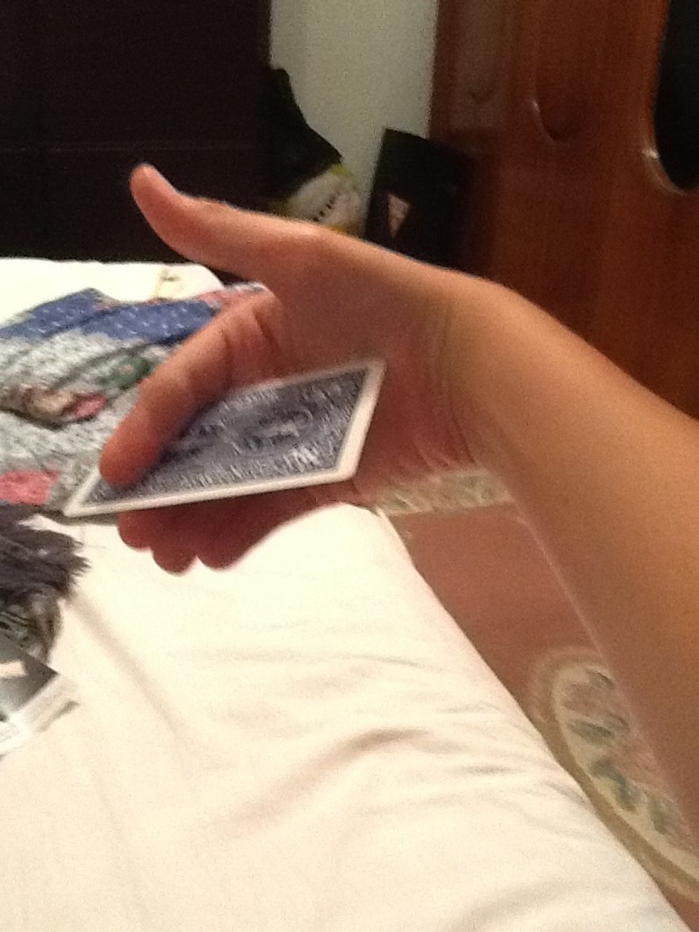 You hold like this and then twist your arm as fast as u can and let the card go