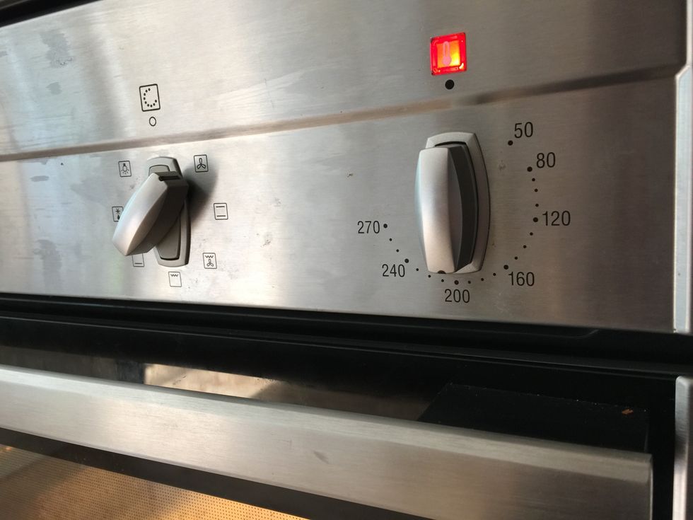 You know your oven. I find that 40 minutes at 200 degrees C works well. Try to hold your nerve and don't take the bread out too soon. The steam will help make a good crust.