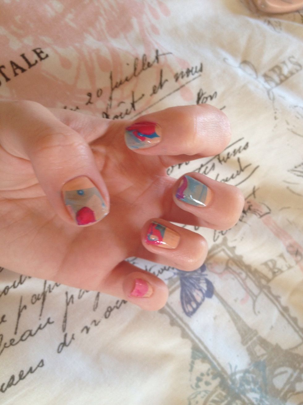 You'll end up with these marble effect nails. Finish with a top coat of clear varnish. I've found that pastel colours on top of a white base coat also look really cool... Have fun!