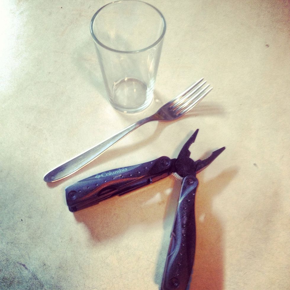 You'll need a fork, pliers and something round like the glass in a picture