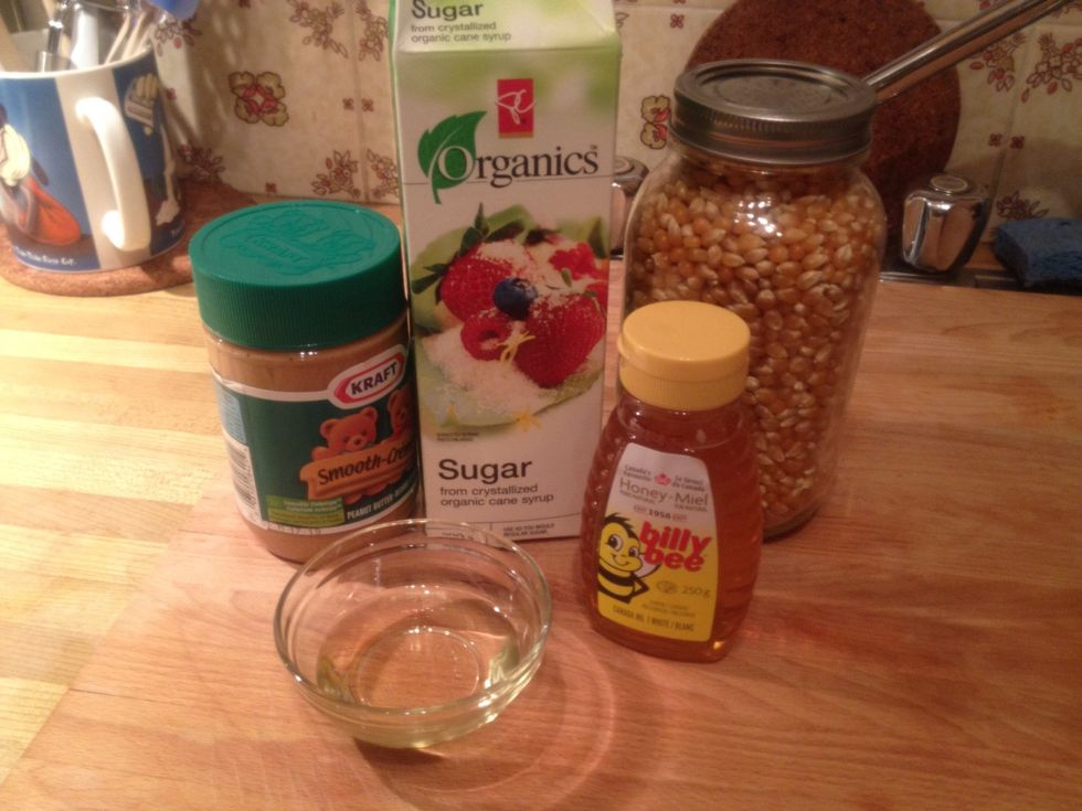 You'll need a half cup of each: popcorn kernels, sugar, peanut butter and honey. Plus a splash of oil if you're cooking your popcorn on the stove top.