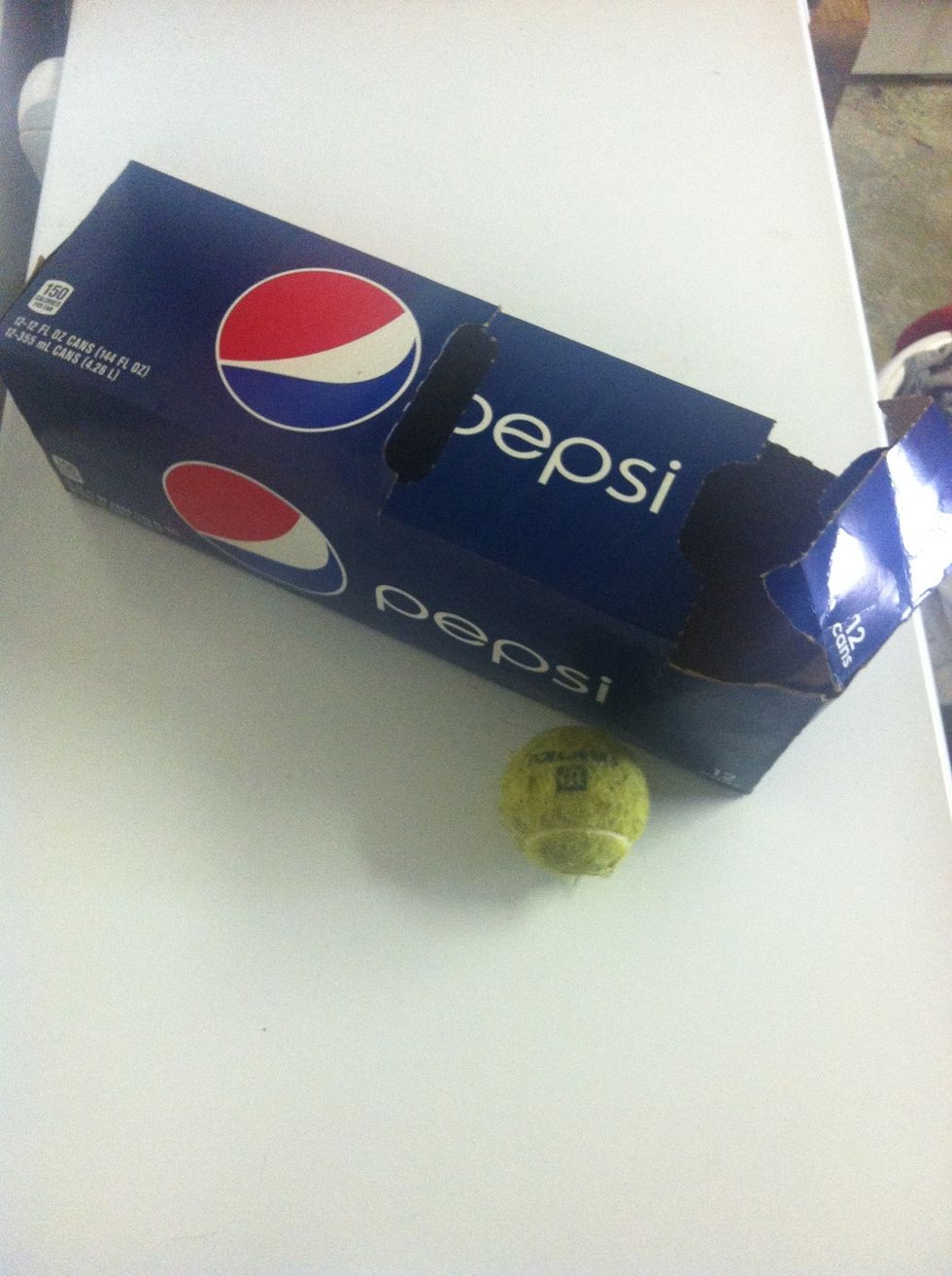 You'll need a tennis ball and a soda box.
