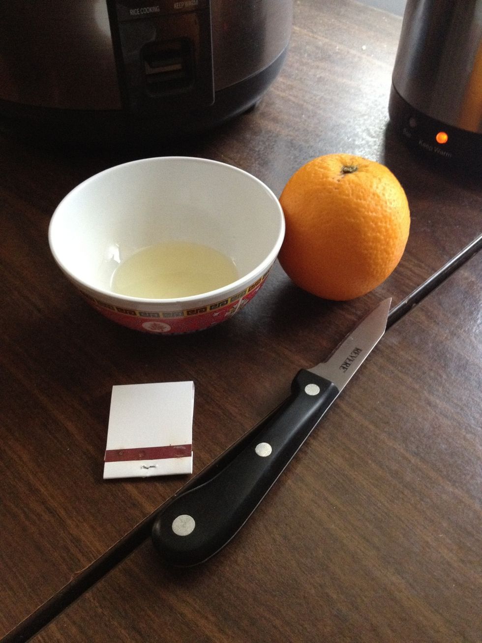 You'll need an orange, oil (any cooking oil), knife, and matches. P.S this doesn't smell like an orange when you light it!