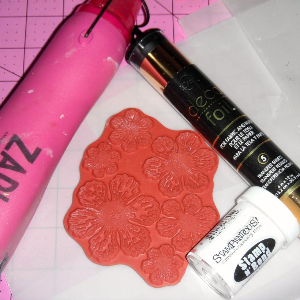 You'll need flower stamps, Deco Foil, Stamp 'n Bond adhesive powder, a heat gun and pigment ink.