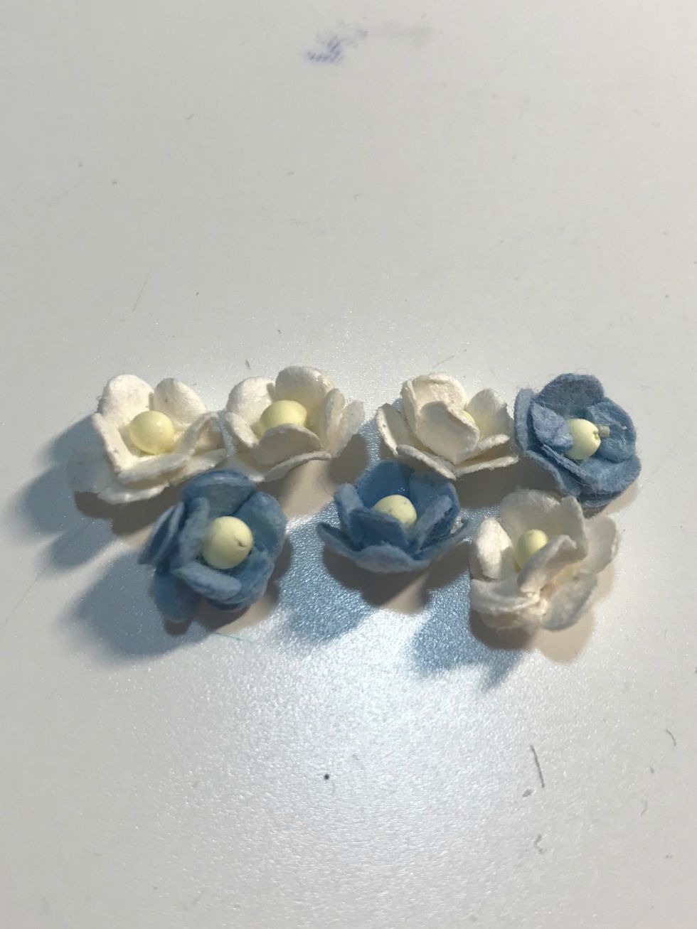 You'll need four white small flowers and three blue flowers.