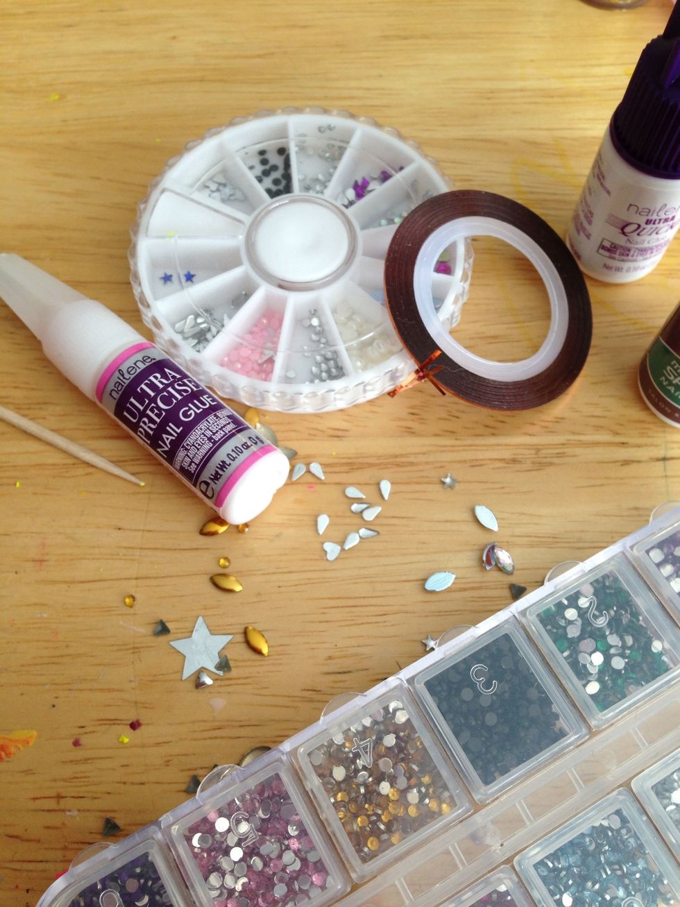 You'll need these supplies. Toothpicks or tweezers work great for picking up bling. I may or may not use the nail strip tape, cause it peels off after a couple days even with proper adhesion.