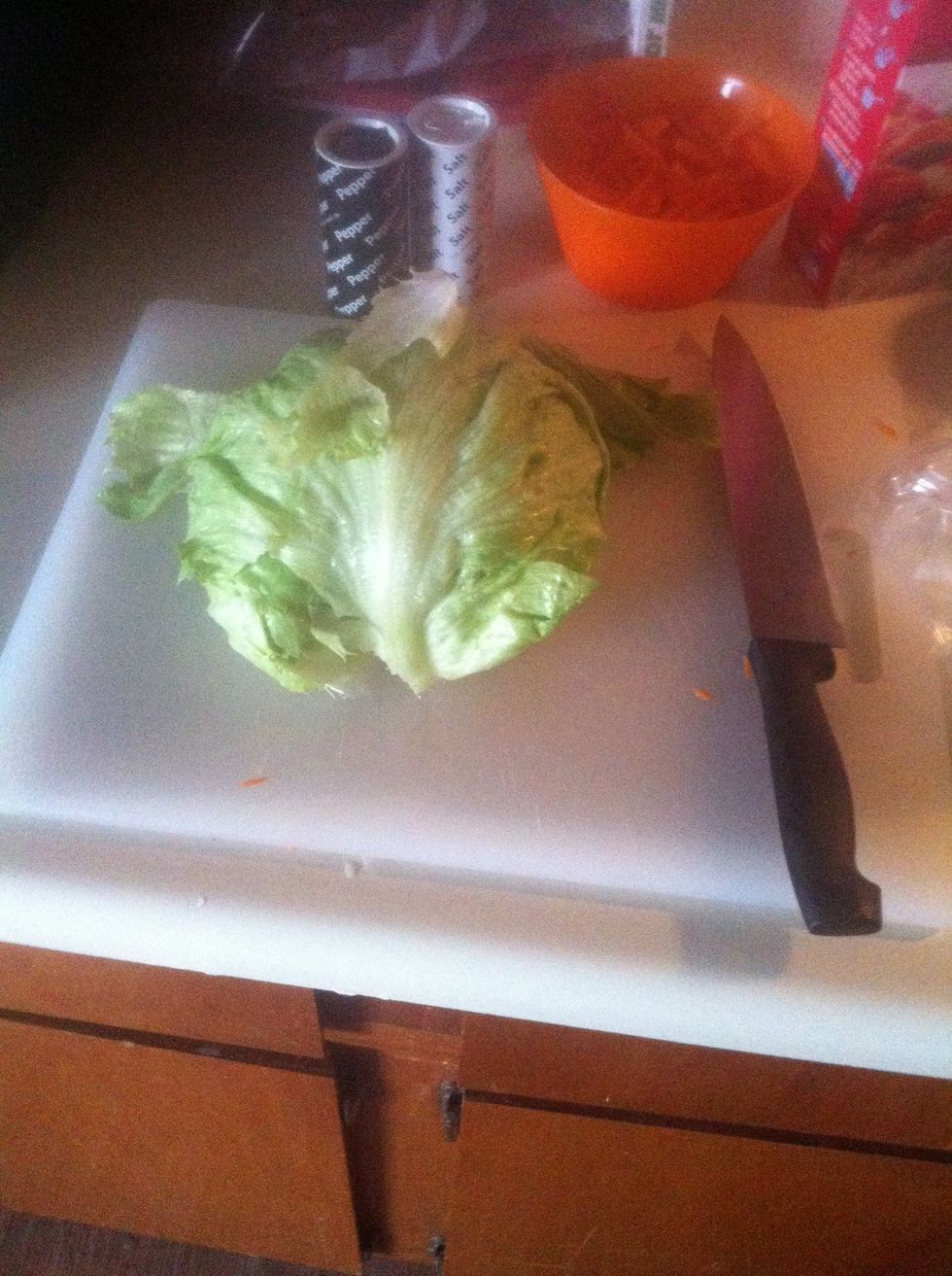 You'll only need a half head of lettuce. Clean it, slice it down the middle, and start slicing.