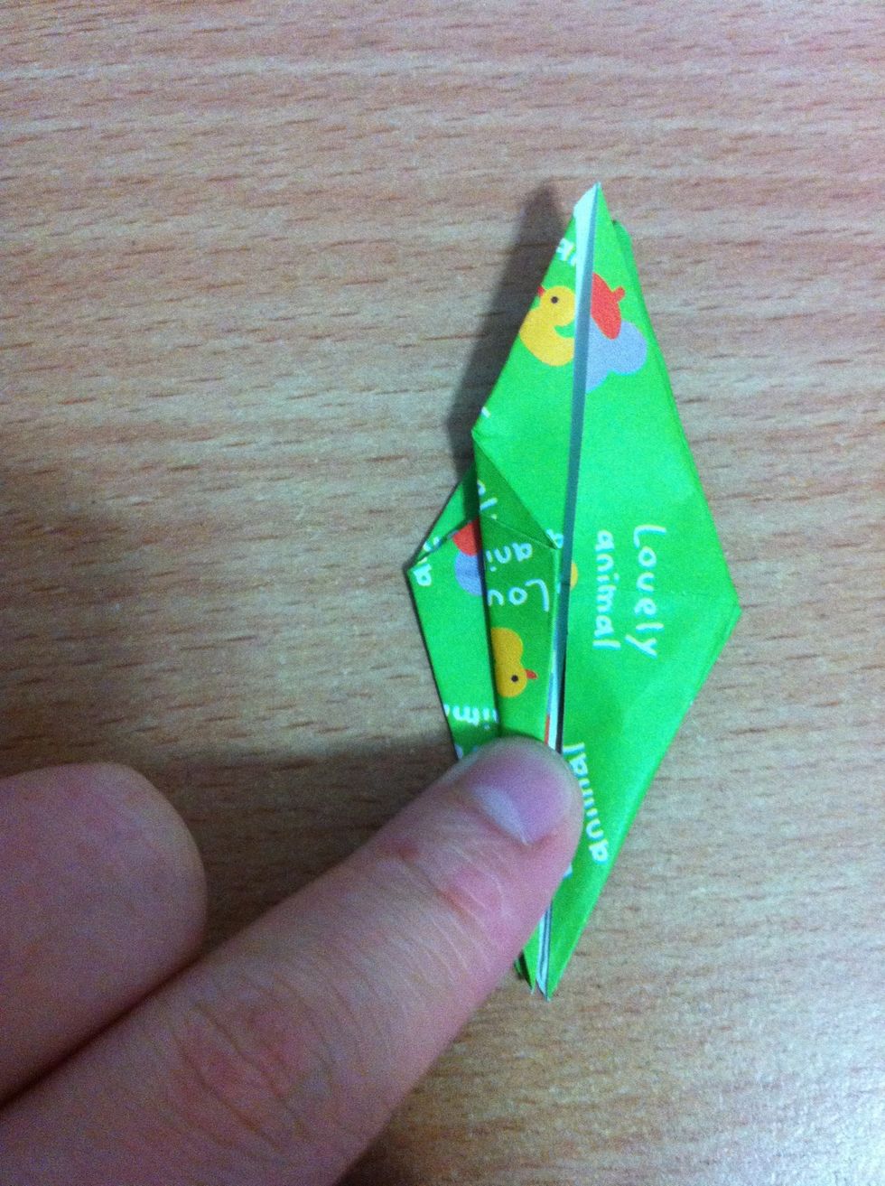 You'll see two halves, the bottom half splits. Using that side, fold the side in to meet the middle
