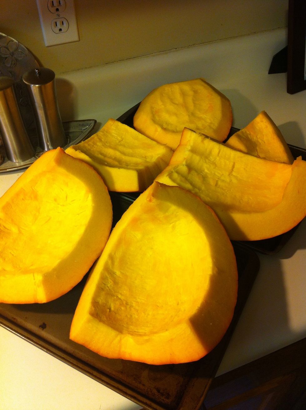 You'll want to clean out the inside of the pumpkin and lay it out on baking sheets.  {Got a bunch of pumpkin guts leftover? Go check out my SnapGuide on roasting pumpkin seeds for a tasty snack!}