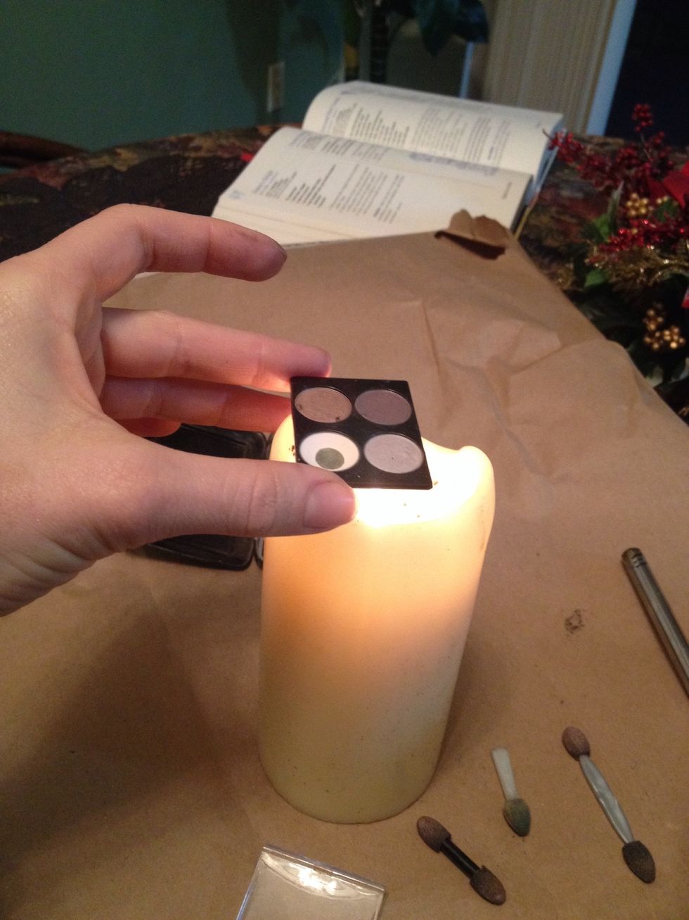 You may have to warm eyeshadow base over a candle for ten seconds or so to soften the glue on the bottom.  This also softens plastic slightly and can allow knife a tweezers more room to pry.