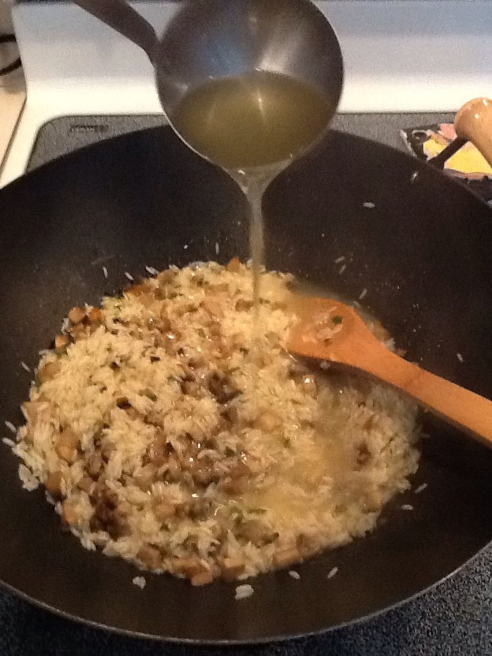 You may need to transfer mixture to a large pot (or you can cook the entire recipe in a wok if you like.). Add 1/2 cup of chicken stock and stir constantly until liquid is absorbed.