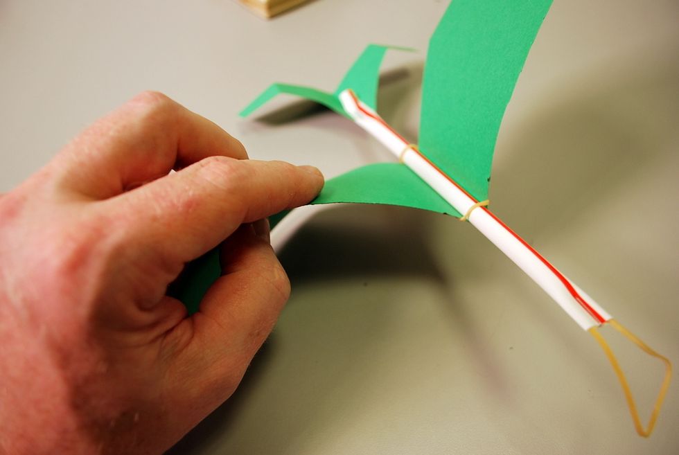 You might add a little curve and twist to the wings.