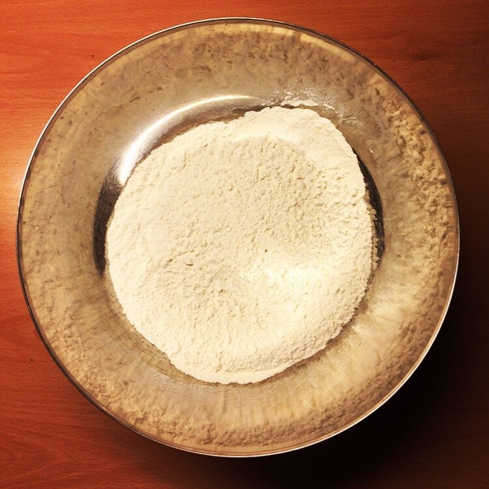 You mix ingredients for the dough in a bowl