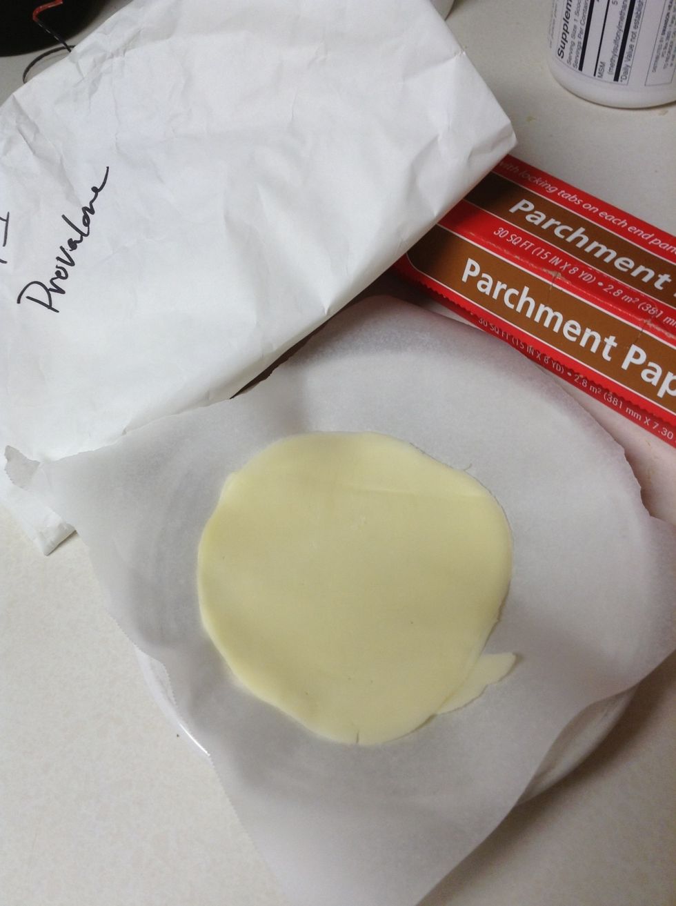 You need parchment paper, any type of cheese. You want and a plate
