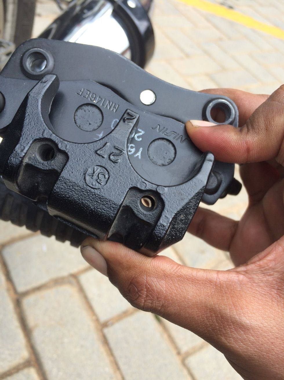 You need to push the pads to align them to get a through hole so the retaining pins can be guided in